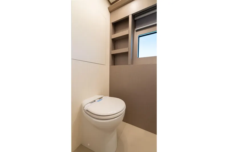 Slide: The Image of Modern bathroom interior on 2027 Pardo Yachts E72, featuring sleek toilet and shelving. - 14