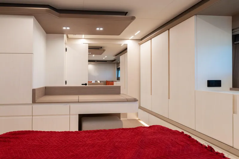 Slide: The Image of Luxurious interior of 2027 Pardo Yachts E72 with modern design and red bedding. - 11