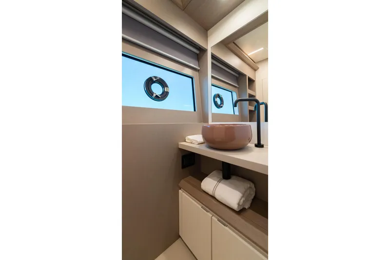 Slide: The Image of Luxurious bathroom interior of 2027 Pardo Yachts E72 with modern sink and porthole windows. - 13