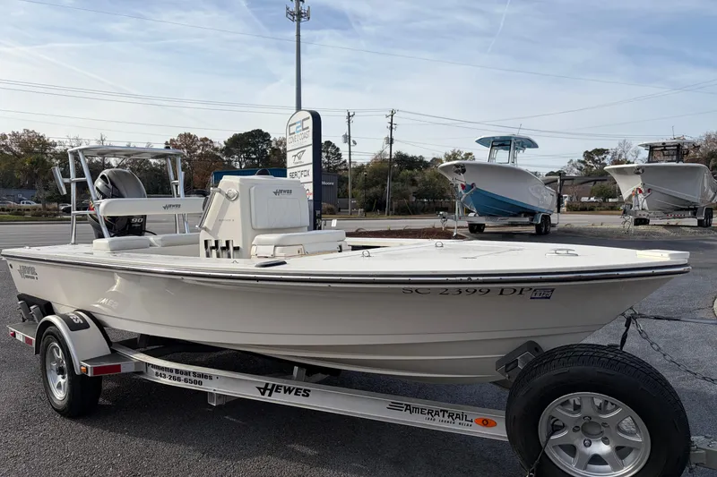Slide: The Image of 2021 Hewes Redfisher 16 boat on trailer in outdoor dealership setting. - 2