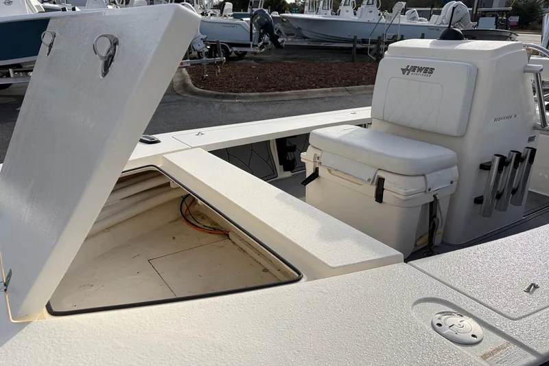Slide: The Image of 2021 Hewes Redfisher 16 boat with open storage compartment and cushioned seating. - 3
