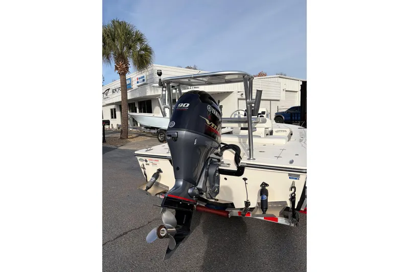 Slide: The Image of 2021 Hewes Redfisher 16 boat with Yamaha 90 outboard motor, parked outdoors. - 8
