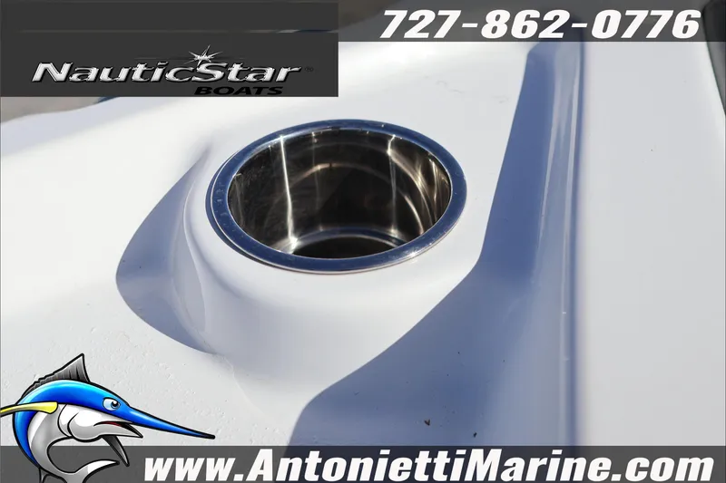 Slide: The Image of 2026 NauticStar 231 Hybrid boat detail with cup holder, contact info, and logo. - 13