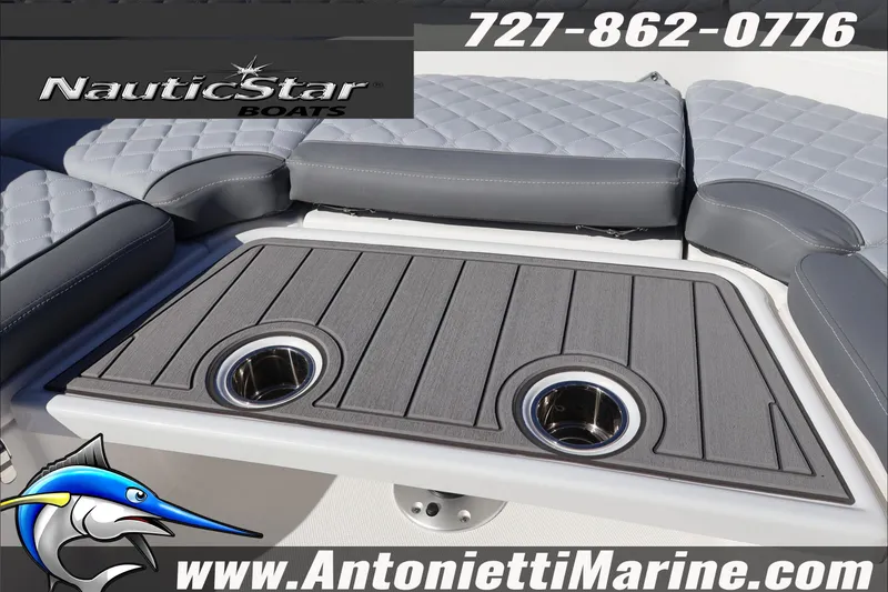 Slide: The Image of 2026 NauticStar 231 Hybrid boat interior with cushioned seating and cup holders. - 17