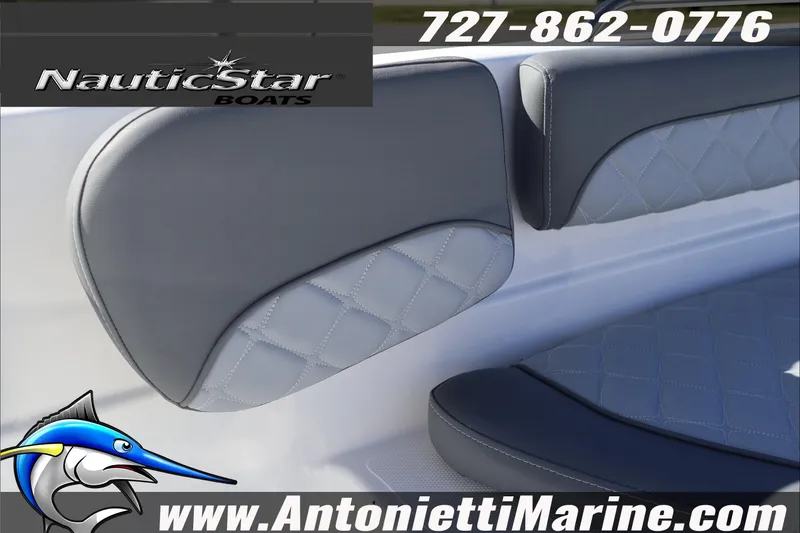 Slide: The Image of NauticStar 231 Hybrid 2026 boat interior with quilted seating, contact details, and logo. - 19