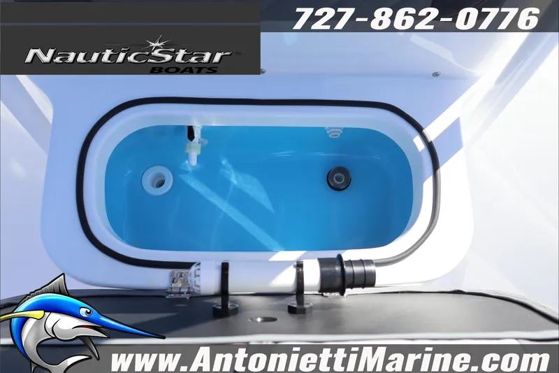 Slide: The Image of 2026 NauticStar 231 Hybrid boat livewell, featuring blue interior and branding details. - 24