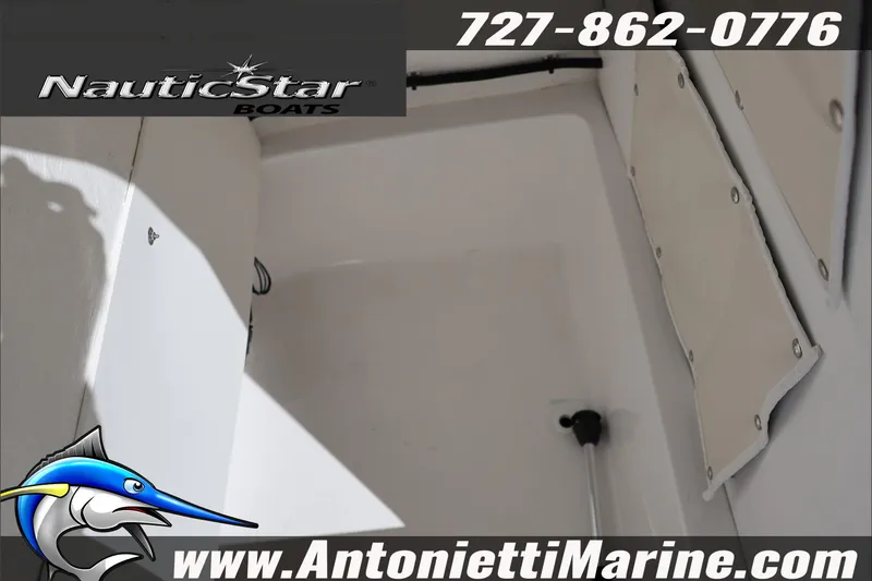 Slide: The Image of 2026 NauticStar 231 Hybrid boat interior detail, featuring storage area and branding. - 41