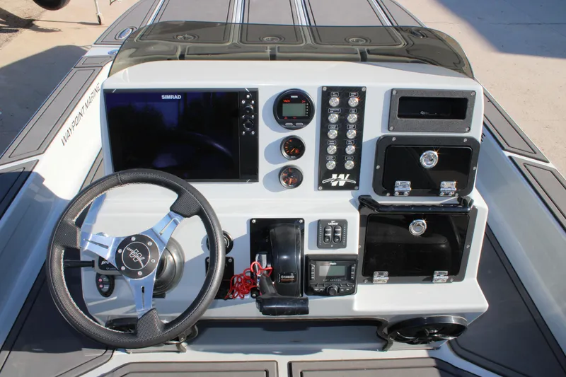 Slide: The Image of Control panel of 2025 Mamba 227VX boat with steering wheel and navigation system. - 11