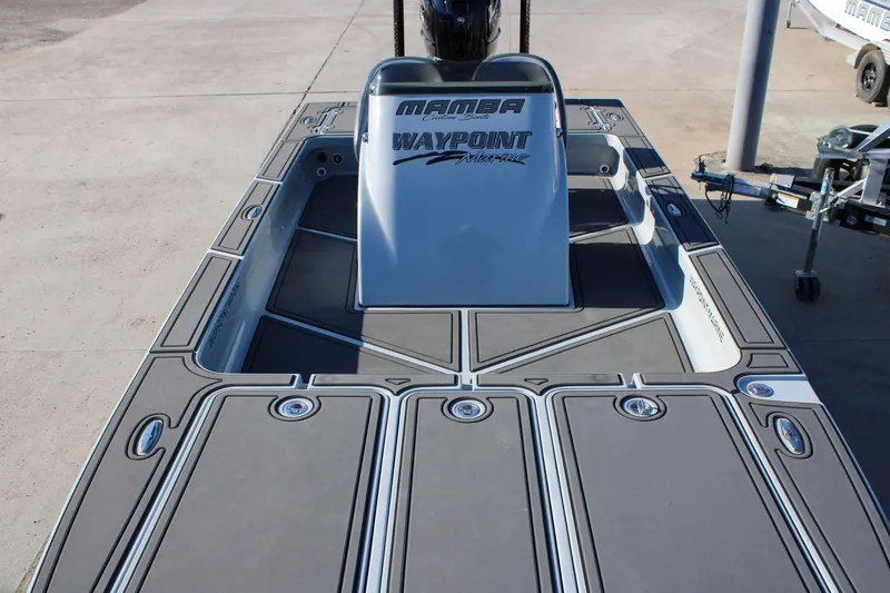 Slide: The Image of 2025 Mamba 227VX boat deck with Waypoint Marine branding, featuring sleek design and storage compartments. - 6