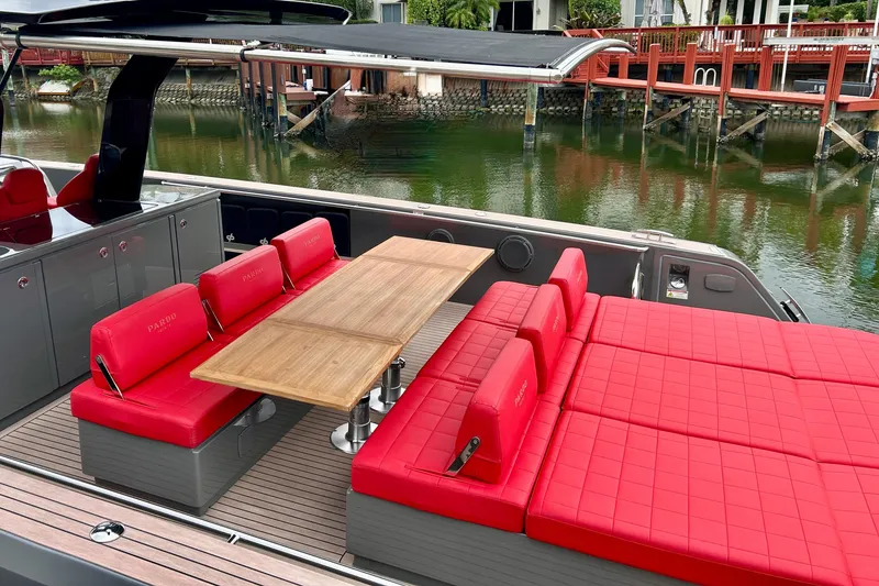 Slide: The Image of 2023 Pardo Yachts 43 with red seating and wooden table on deck. - 11