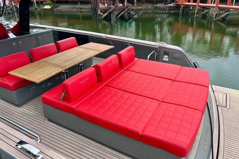Slide: The Image of 2023 Pardo Yachts 43 with red seating and wooden table on deck. - 12