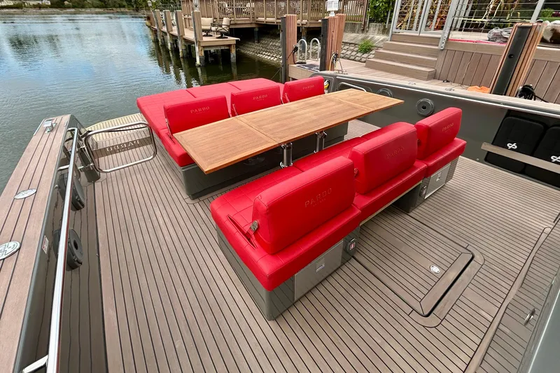 Slide: The Image of 2023 Pardo Yachts 43 with red seating and wooden table on deck. - 15