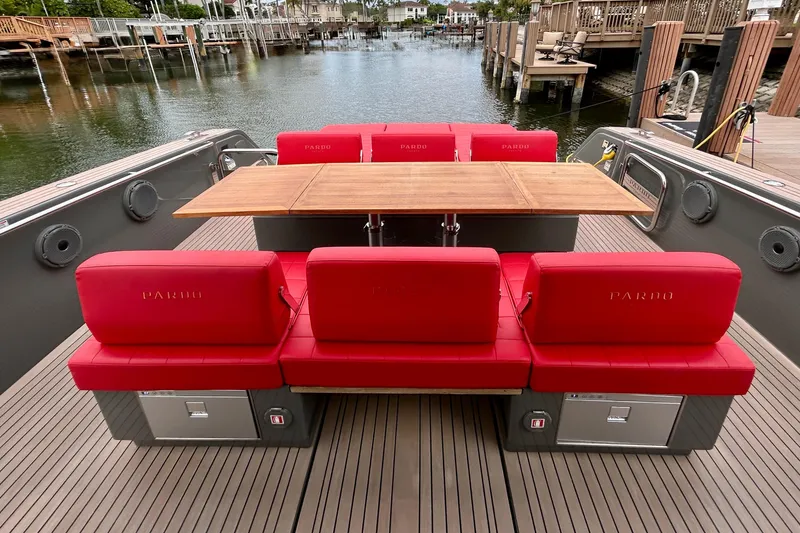 Slide: The Image of 2023 Pardo Yachts 43 with red seating and wooden table on deck. - 16