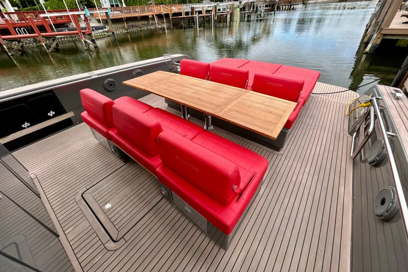 Slide: The Image of Luxury Pardo Yachts 43, 2023 model, featuring red seating and wooden table on deck. - 18
