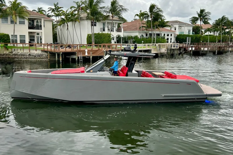 Slide: The Image of 2023 Pardo Yachts 43 cruising near waterfront homes with palm trees. - 2