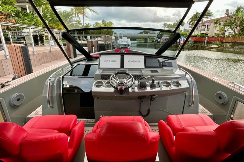Slide: The Image of 2023 Pardo Yachts 43 cockpit with red seats and advanced navigation system. - 29