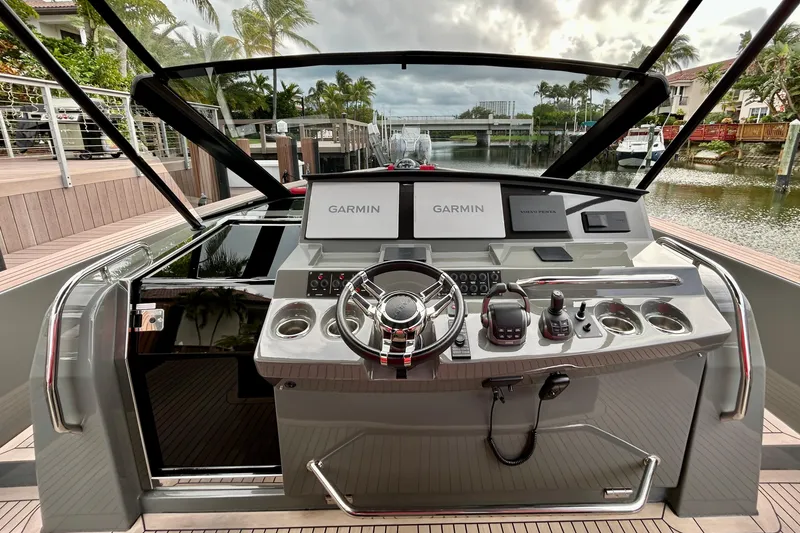 Slide: The Image of Helm of 2023 Pardo Yachts 43 with Garmin navigation, docked by a scenic canal. - 30