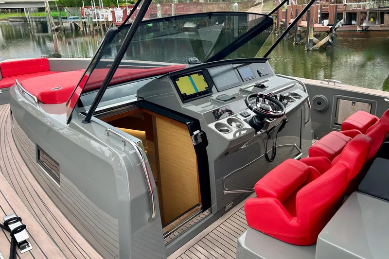 Slide: The Image of 2023 Pardo Yachts 43 cockpit with red seats and modern navigation controls. - 32