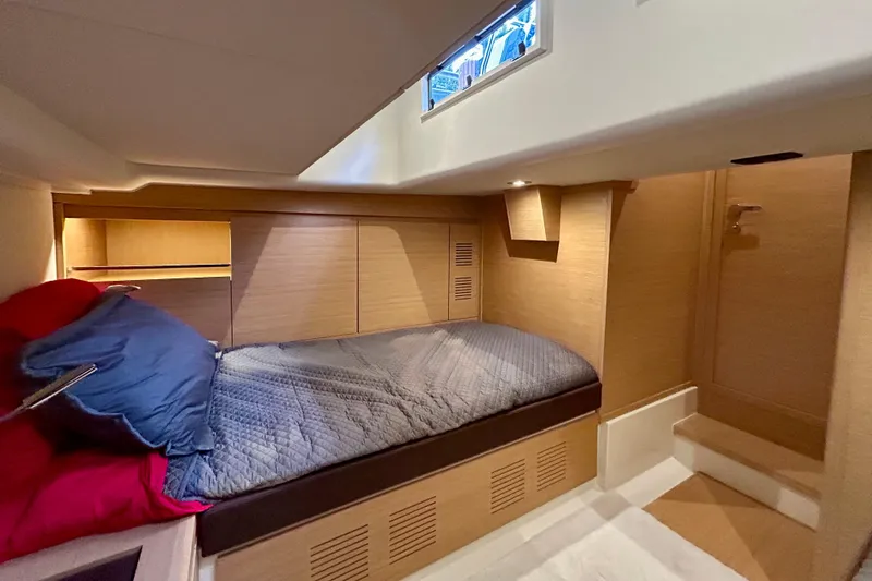 Slide: The Image of Luxurious cabin interior of 2023 Pardo Yachts 43, featuring cozy bedding and elegant wood finishes. - 46