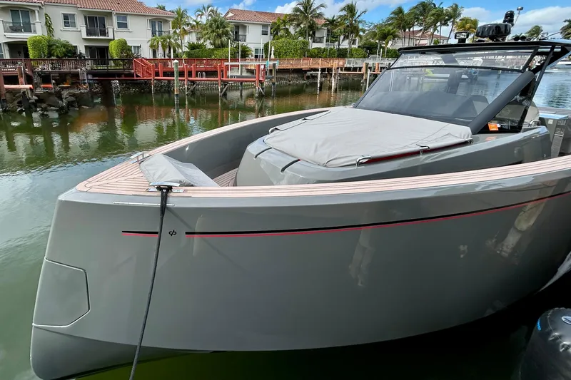 Slide: The Image of 2023 Pardo Yachts 43 docked near waterfront homes, showcasing sleek design and modern features. - 59