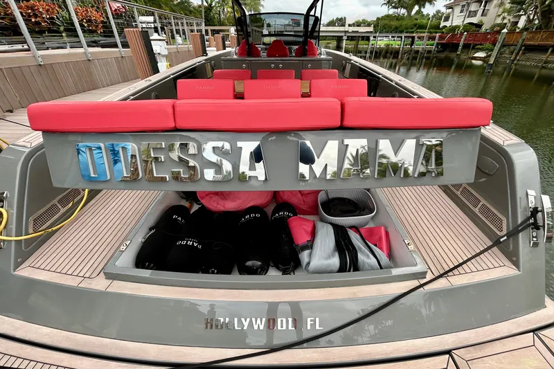Slide: The Image of 2023 Pardo Yachts 43 docked, featuring red seating and "Odessa Mama" nameplate. - 10