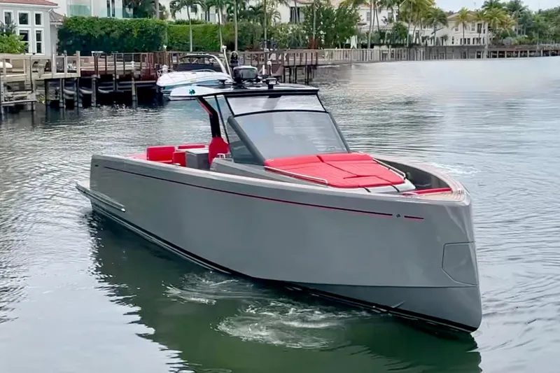 Slide: The Image of 2023 Pardo Yachts 43 in sleek gray with red accents cruising on calm water. - 4