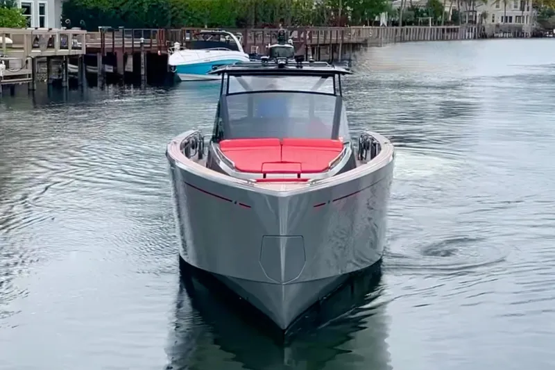 Slide: The Image of 2023 Pardo Yachts 43 in water, sleek design with red seating, dockside view. - 5