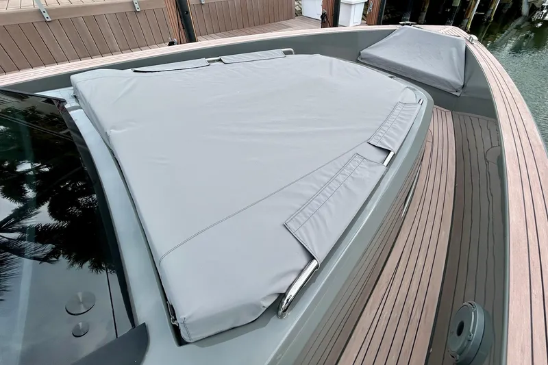 Slide: The Image of 2023 Pardo Yachts 43 with covered deck area, featuring sleek wooden finishes. - 56