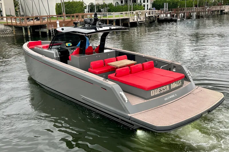 Slide: The Image of 2023 Pardo Yachts 43 with red seating, cruising in a marina. - 7