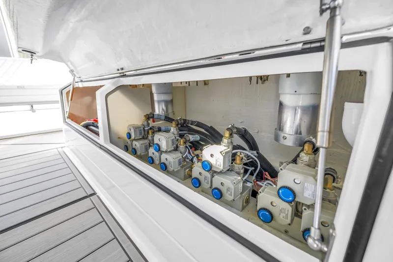 Slide: The Image of 2023 HCB 53 Suenos RXV engine compartment with mechanical components and wiring. - 100