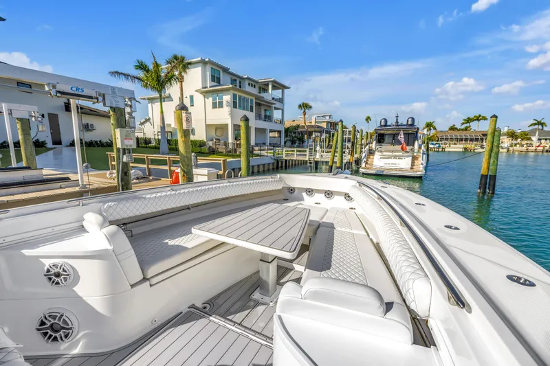 Slide: The Image of 2023 HCB 53 Suenos RXV luxury boat docked at marina with clear blue skies. - 21
