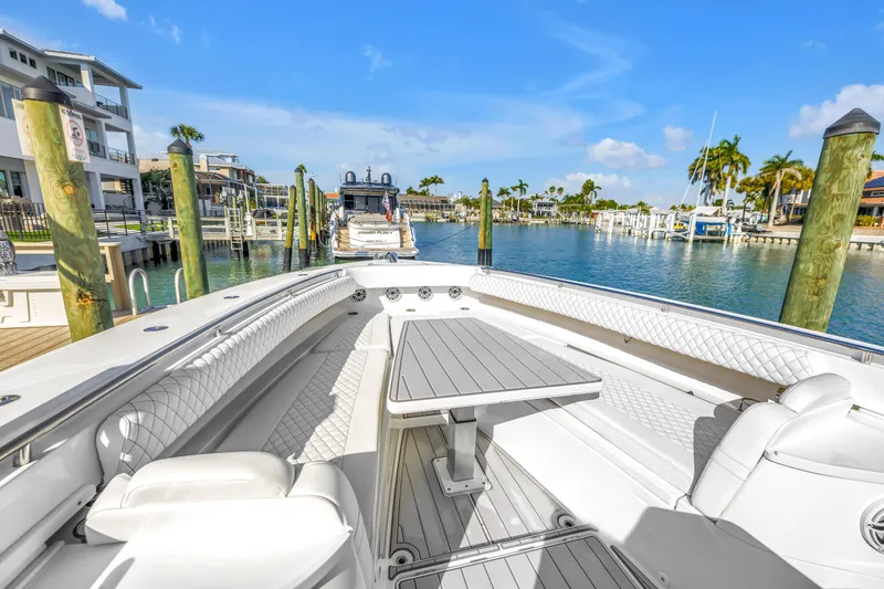 Slide: The Image of 2023 HCB 53 Suenos RXV luxury boat docked in a sunny marina setting. - 22