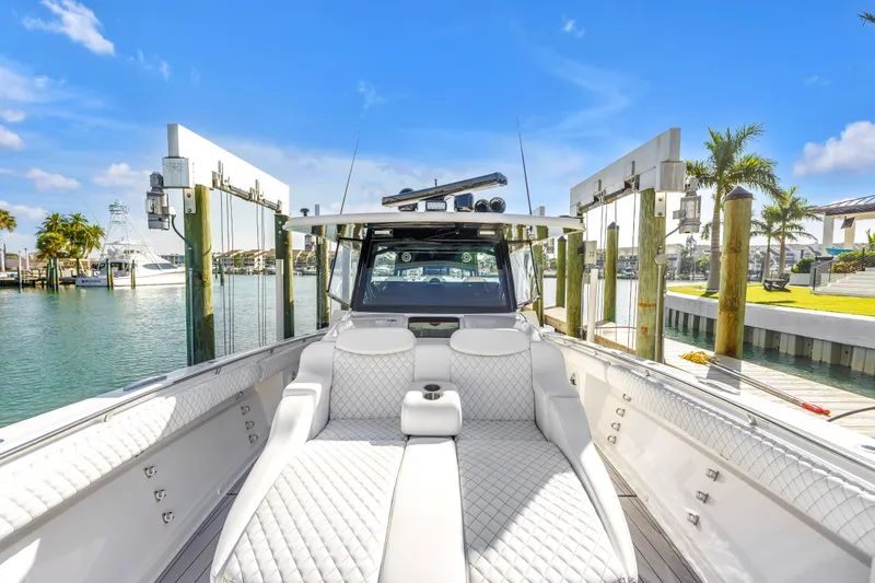 Slide: The Image of 2023 HCB 53 Suenos RXV luxury boat docked, featuring elegant white seating and modern design. - 29