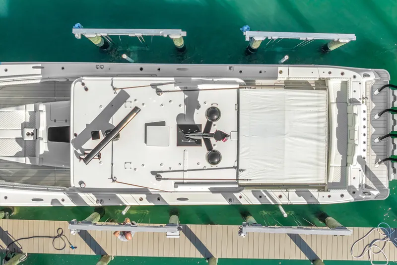 Slide: The Image of Aerial view of 2023 HCB 53 Suenos RXV yacht docked in turquoise water. - 32