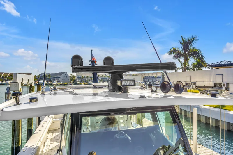 Slide: The Image of 2023 HCB 53 Suenos RXV yacht docked, showcasing advanced navigation equipment under clear blue skies. - 37