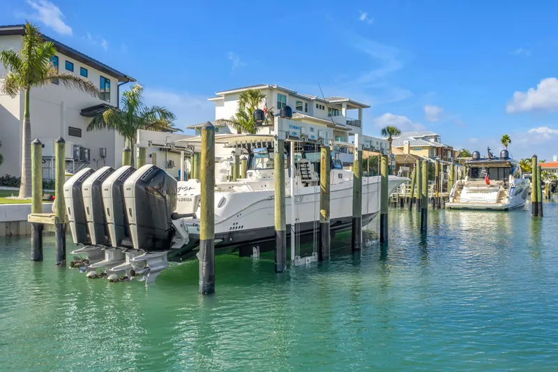 Slide: The Image of 2023 HCB 53 Suenos RXV boat docked in a sunny marina setting. - 4