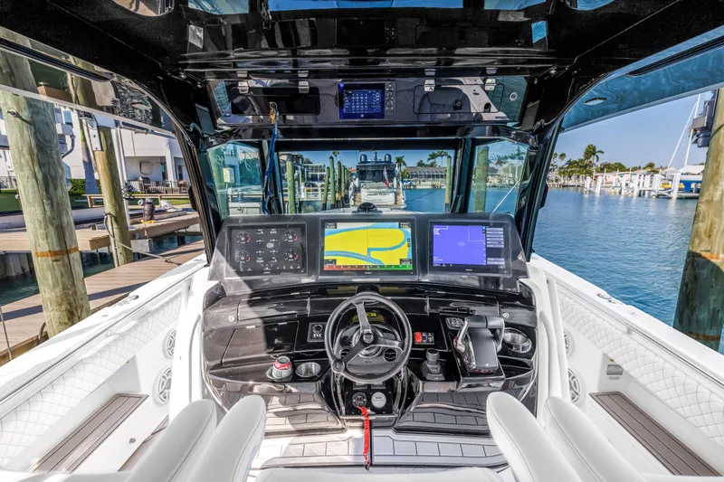 Slide: The Image of 2023 HCB 53 Suenos RXV boat cockpit with advanced navigation displays and controls. - 41