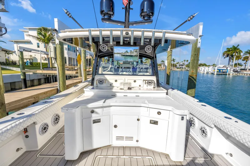Slide: The Image of 2023 HCB 53 Suenos RXV luxury boat docked in a sunny marina setting. - 56