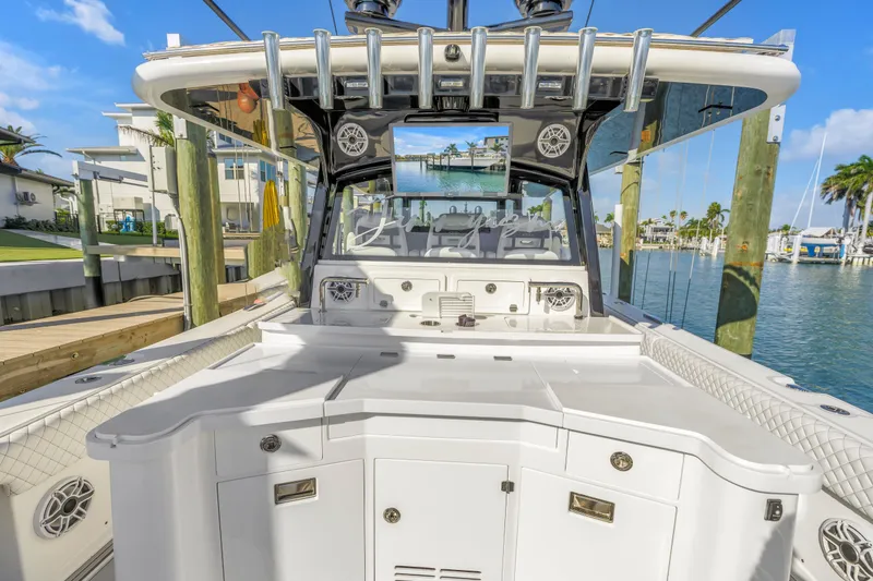 Slide: The Image of 2023 HCB 53 Suenos RXV luxury boat docked in a marina, showcasing sleek design. - 57