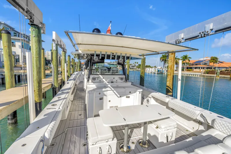 Slide: The Image of 2023 HCB 53 Suenos RXV luxury boat docked in a sunny marina setting. - 58