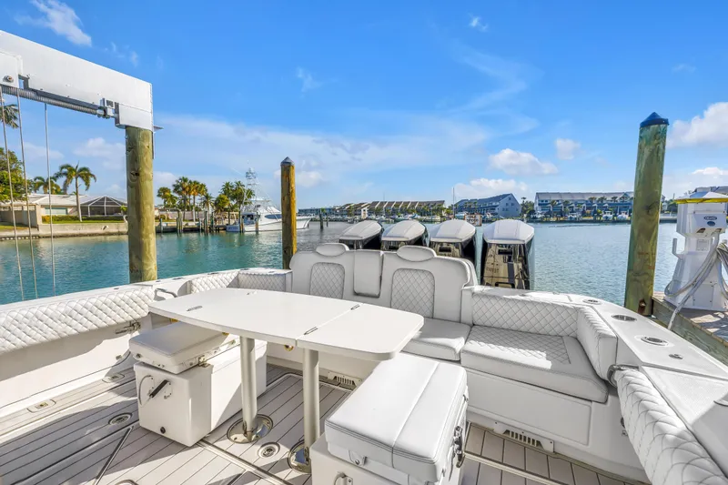 Slide: The Image of 2023 HCB 53 Suenos RXV luxury boat interior with seating and table, docked in a marina. - 66