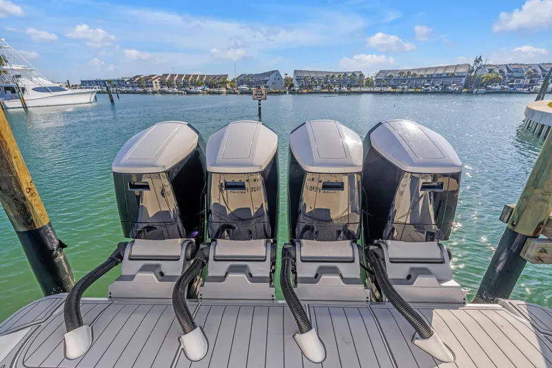 Slide: The Image of 2023 HCB 53 Suenos RXV boat with four powerful outboard engines docked in a marina. - 71
