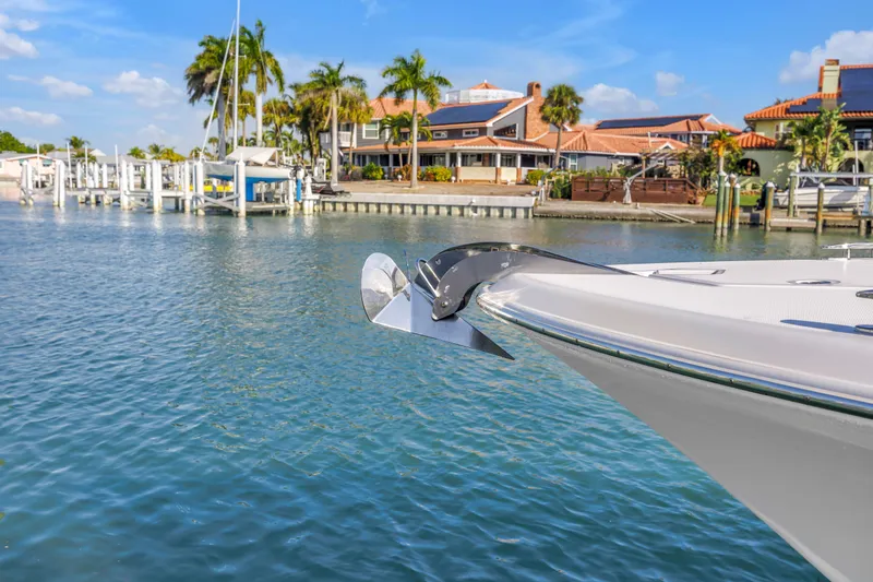 Slide: The Image of 2023 HCB 53 Suenos RXV boat docked near waterfront homes and palm trees. - 8