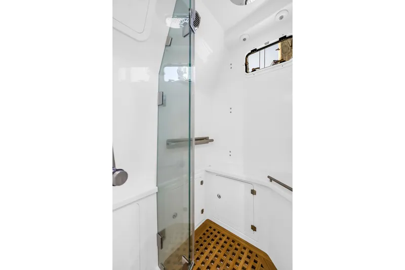 Slide: The Image of 2023 HCB 53 Suenos RXV boat shower with glass door and wooden floor. - 80