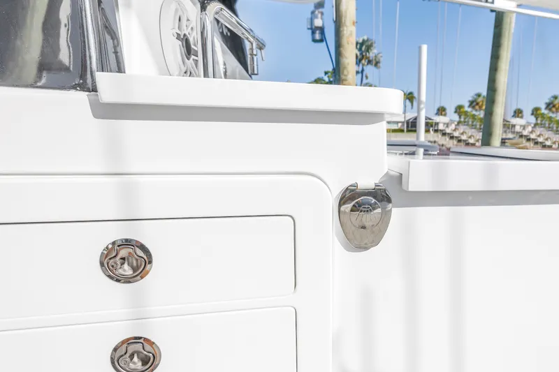 Slide: The Image of 2023 HCB 53 Suenos RXV boat detail with sleek white finish and chrome accents. - 91