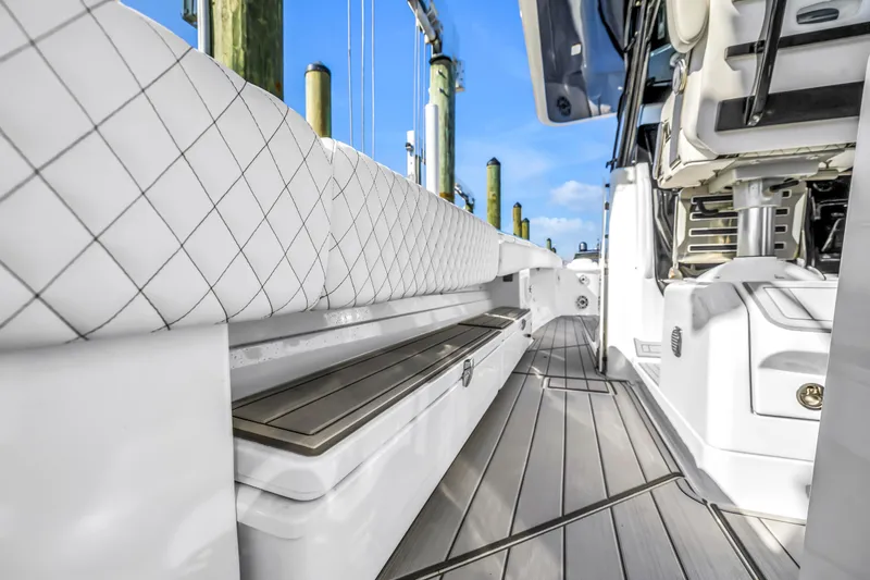 Slide: The Image of 2023 HCB 53 Suenos RXV boat interior with cushioned seating and sleek design. - 94