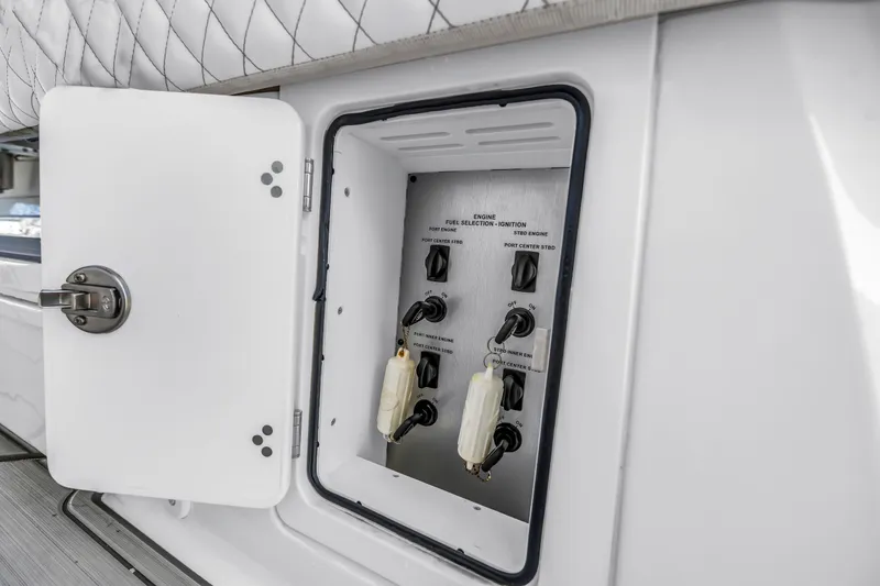Slide: The Image of Control panel inside 2023 HCB 53 Suenos RXV boat, featuring ignition and fuel selection switches. - 98