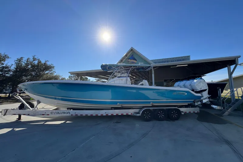 The Image of 2016 Nor-Tech 390 Sport Center Console boat on trailer under sunny sky. - 1