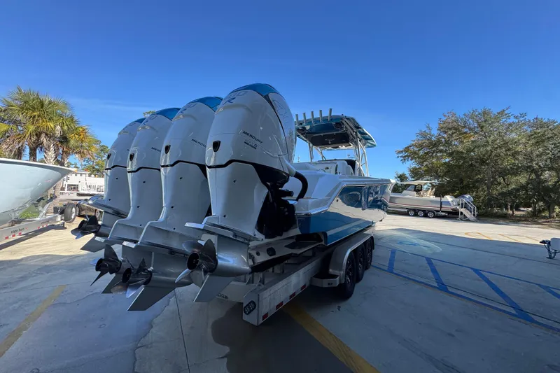 Slide: The Image of 2016 Nor-Tech 390 Sport Center Console boat with multiple outboard engines on a trailer. - 13