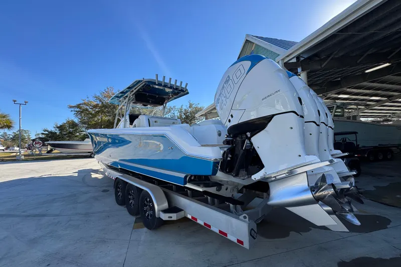 Slide: The Image of 2016 Nor-Tech 390 Sport Center Console boat with triple Mercury engines on a trailer. - 17